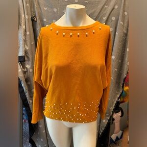 Mustard Yellow sweater with pearls.